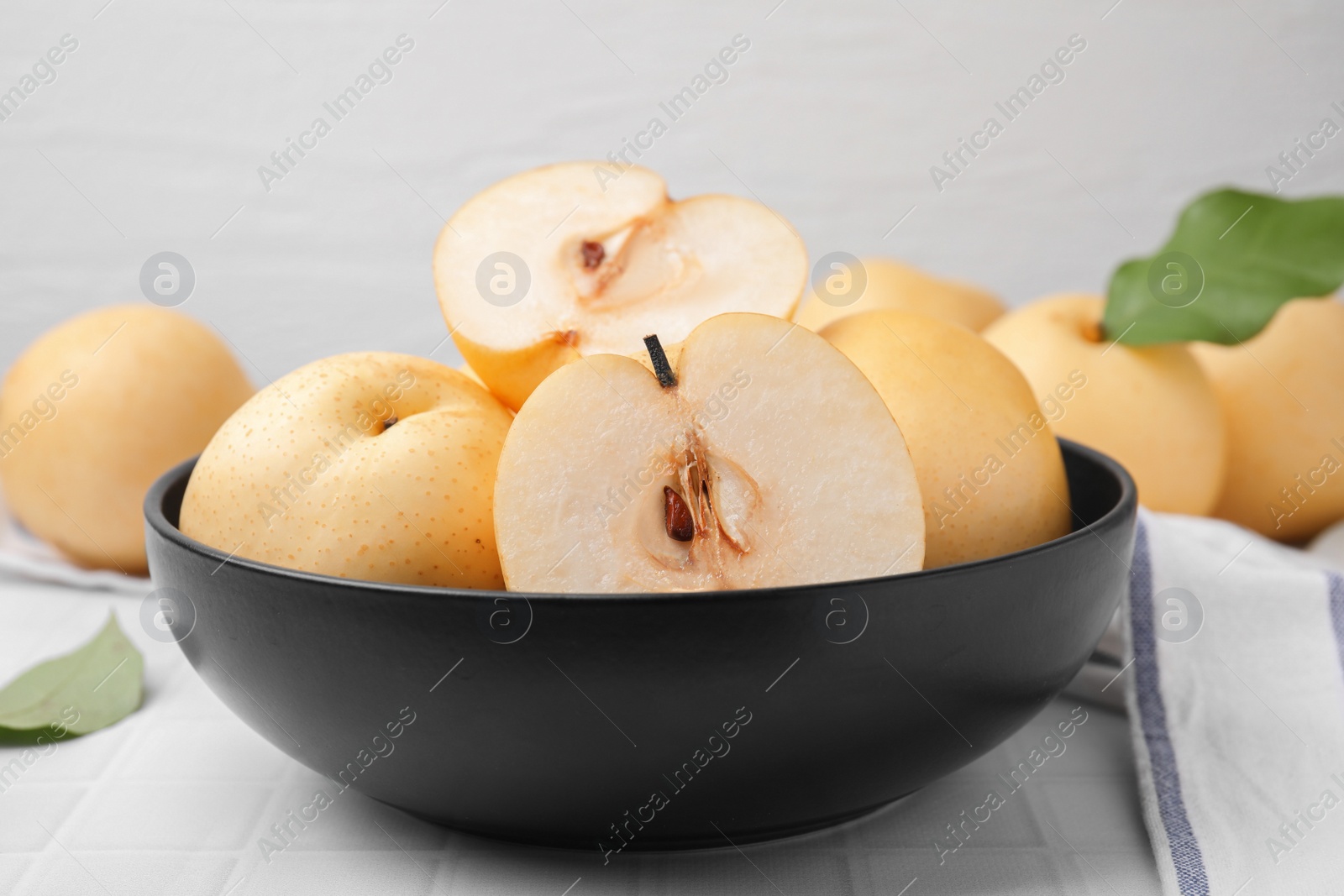 Photo of Delicious apple pears on white tiled table