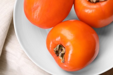 Photo of Delicious ripe persimmons on table, top view