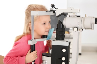 Photo of Cute little girl visiting children's doctor. Eye examination