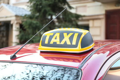 Photo of Roof light with word TAXI on car outdoors