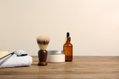 Photo of Set of men's shaving tools on wooden table, space for text