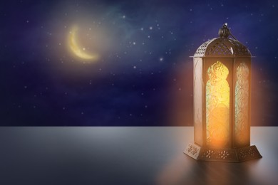 Image of Beautiful decorative Arabic lantern on table at night, space for text. Fanous as Ramadan symbol