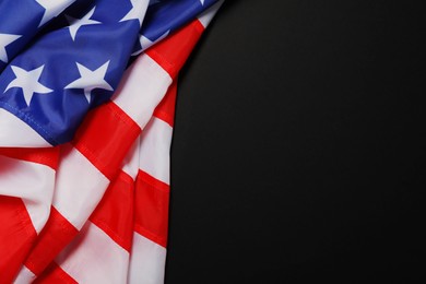 Photo of American flag on black background, top view with space for text