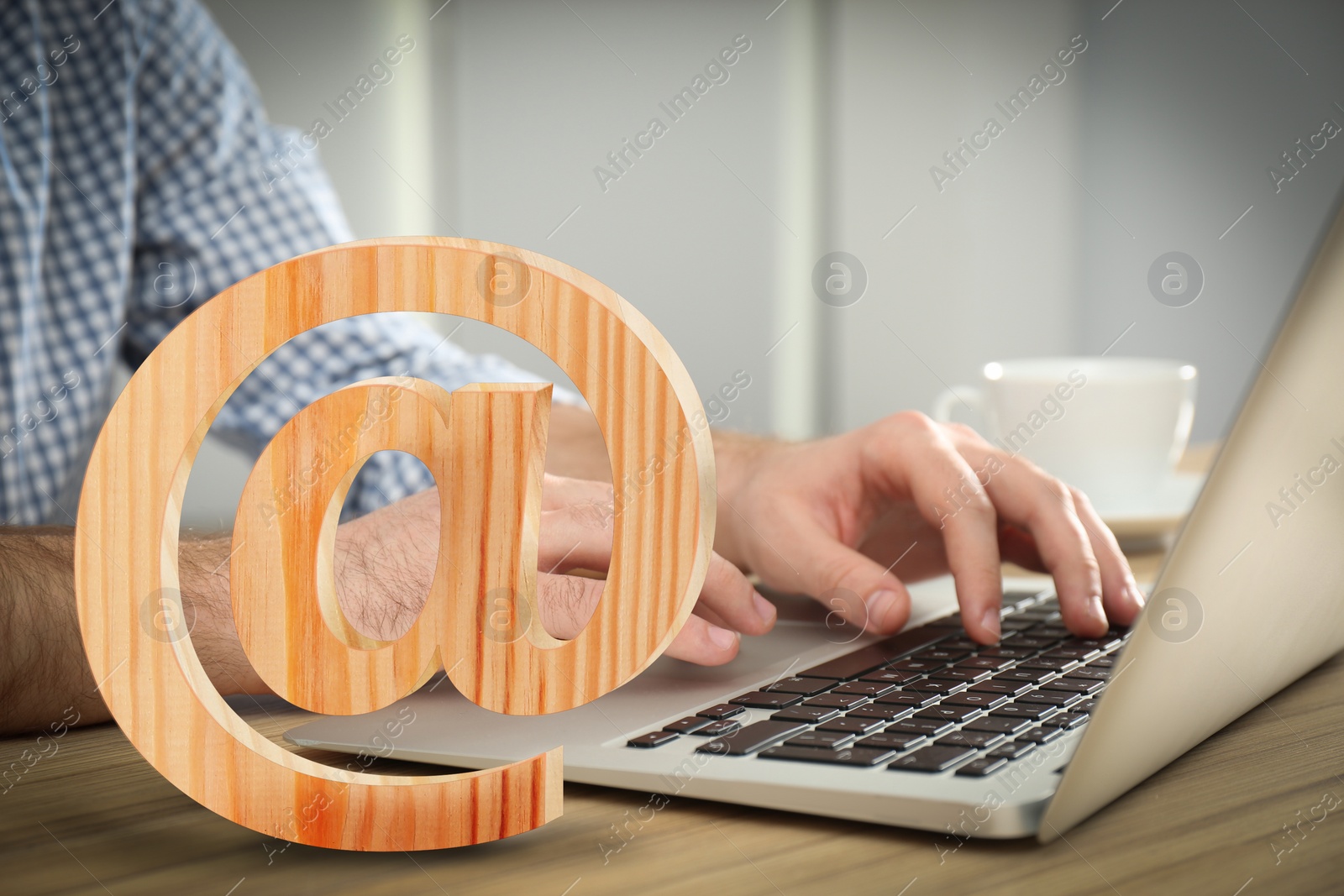 Image of At sign illustration and man sending email via laptop at table, closeup