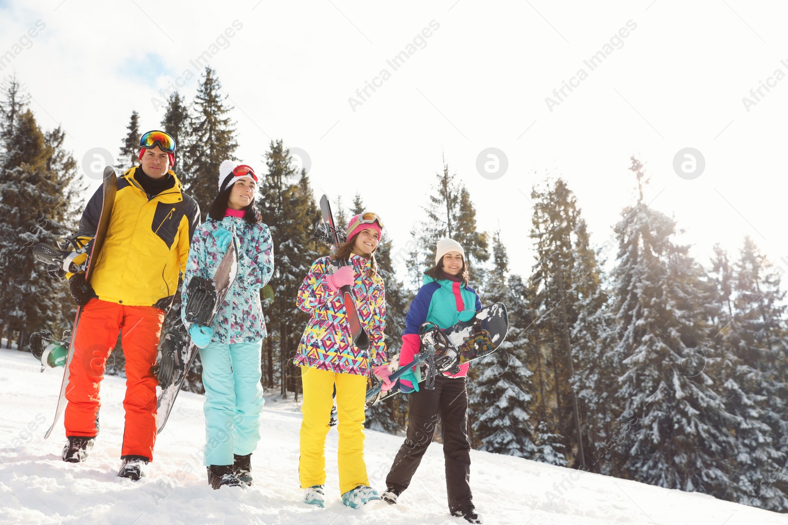 Photo of Group of friends with equipment on snowy slope. Winter vacation