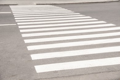 Photo of White pedestrian crossing on empty city street