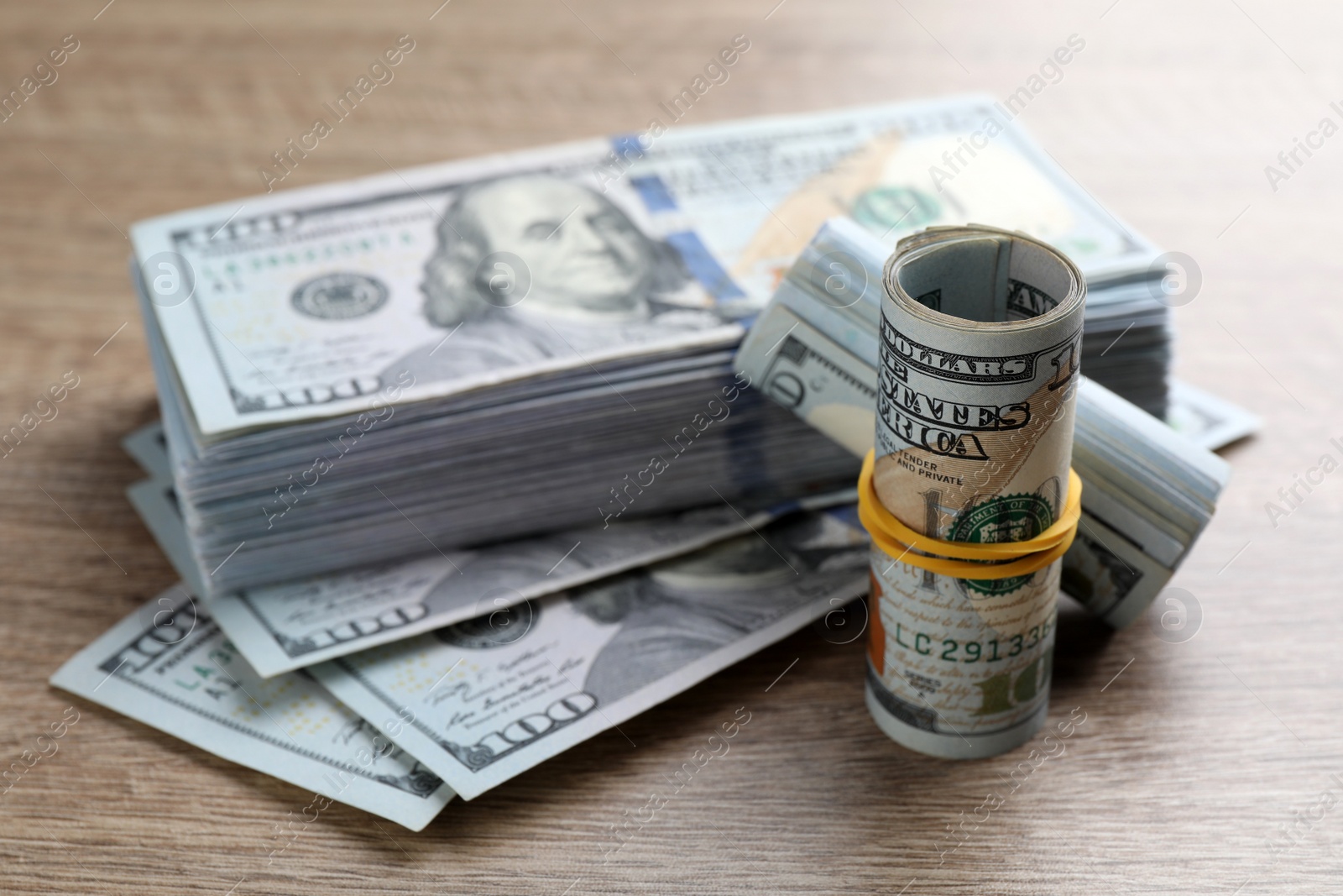 Photo of Many dollar banknotes on wooden table, closeup. American national currency
