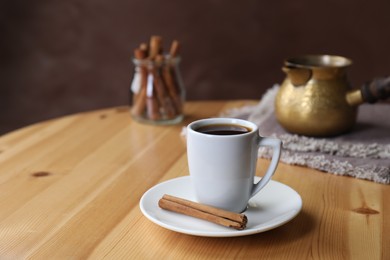 Photo of Turkish coffee. Freshly brewed beverage on wooden table, space for text