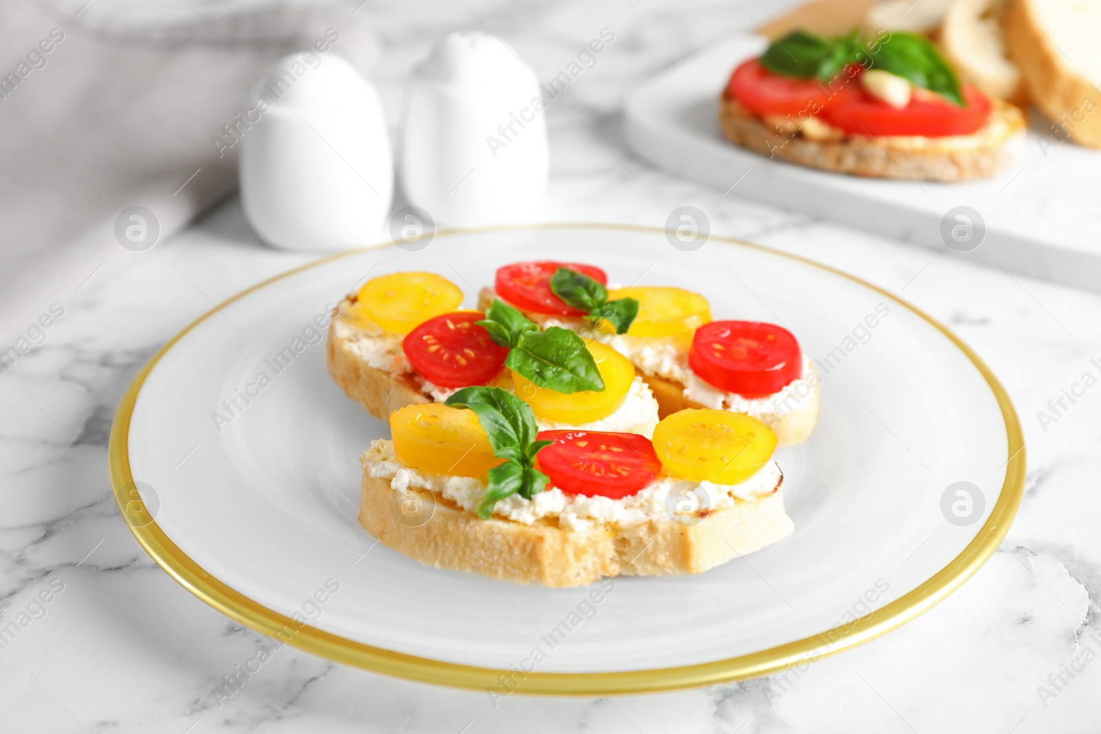 Photo of Tasty fresh tomato bruschettas on marble table