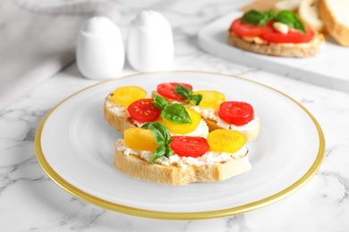 Tasty fresh tomato bruschettas on marble table