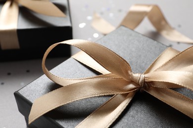 Photo of Beautiful gift box with bow on grey background, closeup view