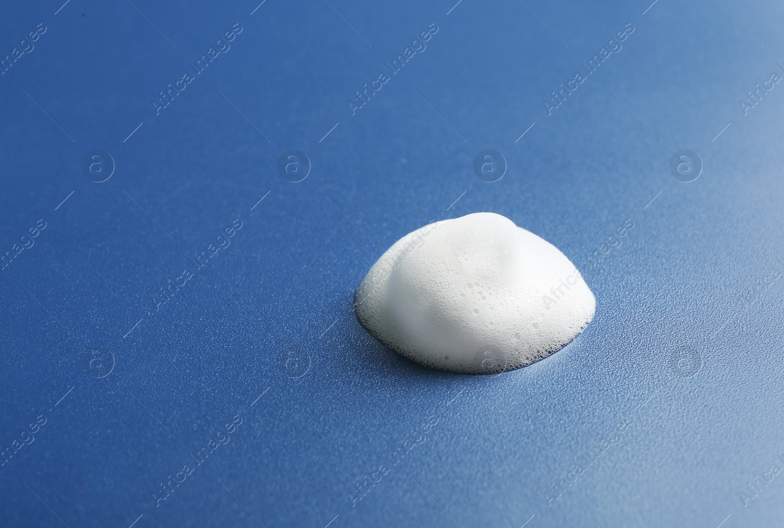 Photo of Drop of soap foam on color background. Space for text