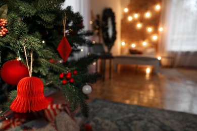 Photo of Christmas tree with festive decor indoors, closeup. Space for text