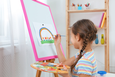 Photo of Cute little child painting during lesson in room