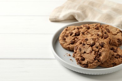 Photo of Delicious chocolate chip cookies on white wooden table. Space for text