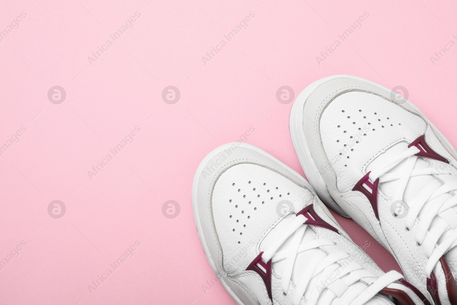 Photo of Pair of stylish shoes on pink background, top view. Space for text