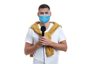 Journalist with microphone wearing medical mask on white background. Virus protection