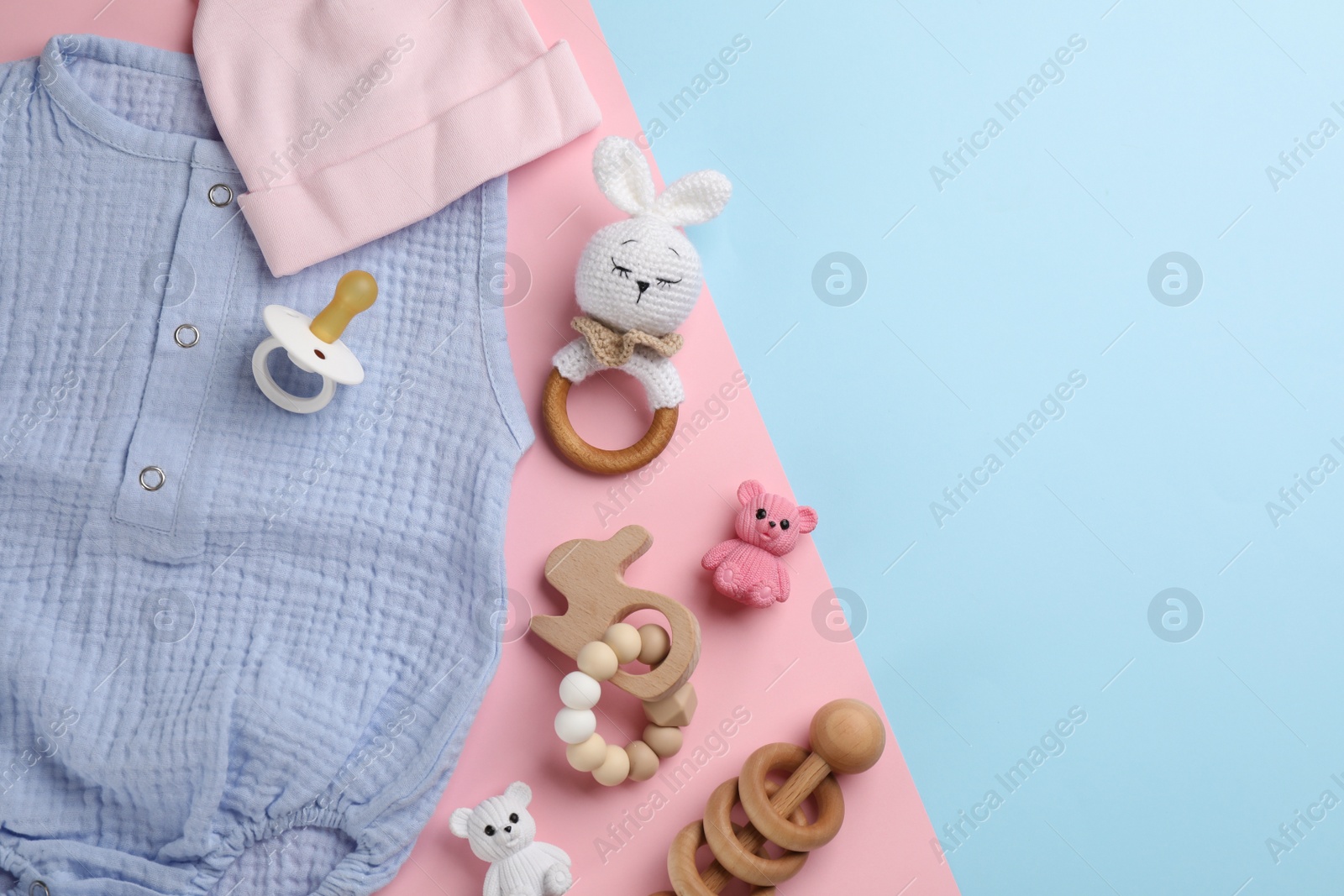 Photo of Flat lay composition with baby clothes and accessories on color background, space for text