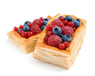 Photo of Fresh delicious puff pastry with sweet berries on white background