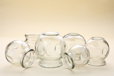 Glass cups on beige background. Cupping therapy