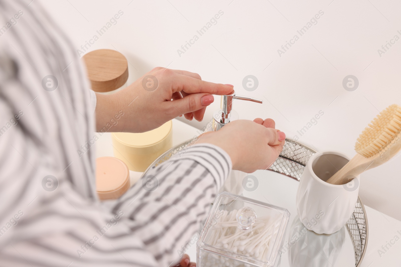 Photo of Bath accessories. Woman applying soap on her hand indoors, closeup