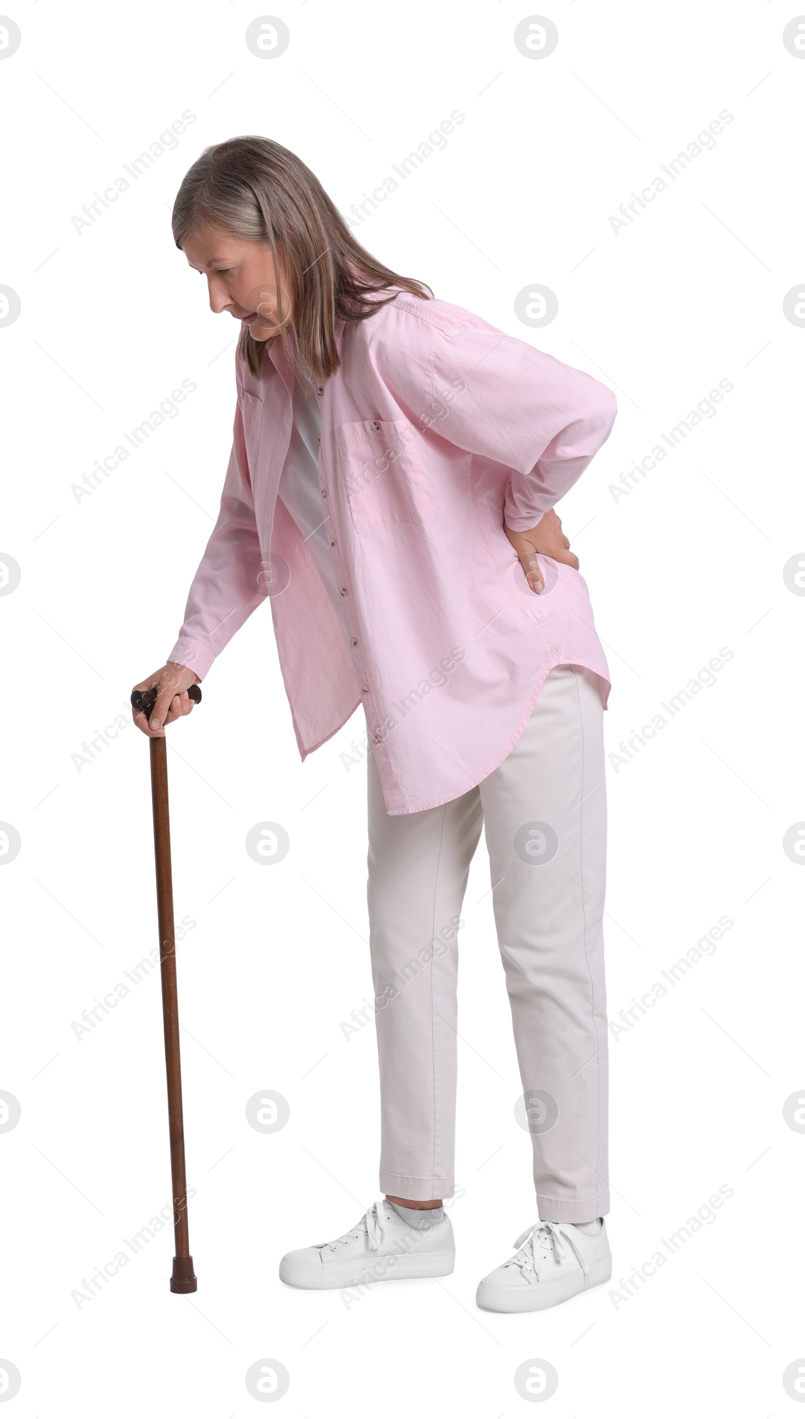 Photo of Senior woman with walking cane suffering from back pain on white background