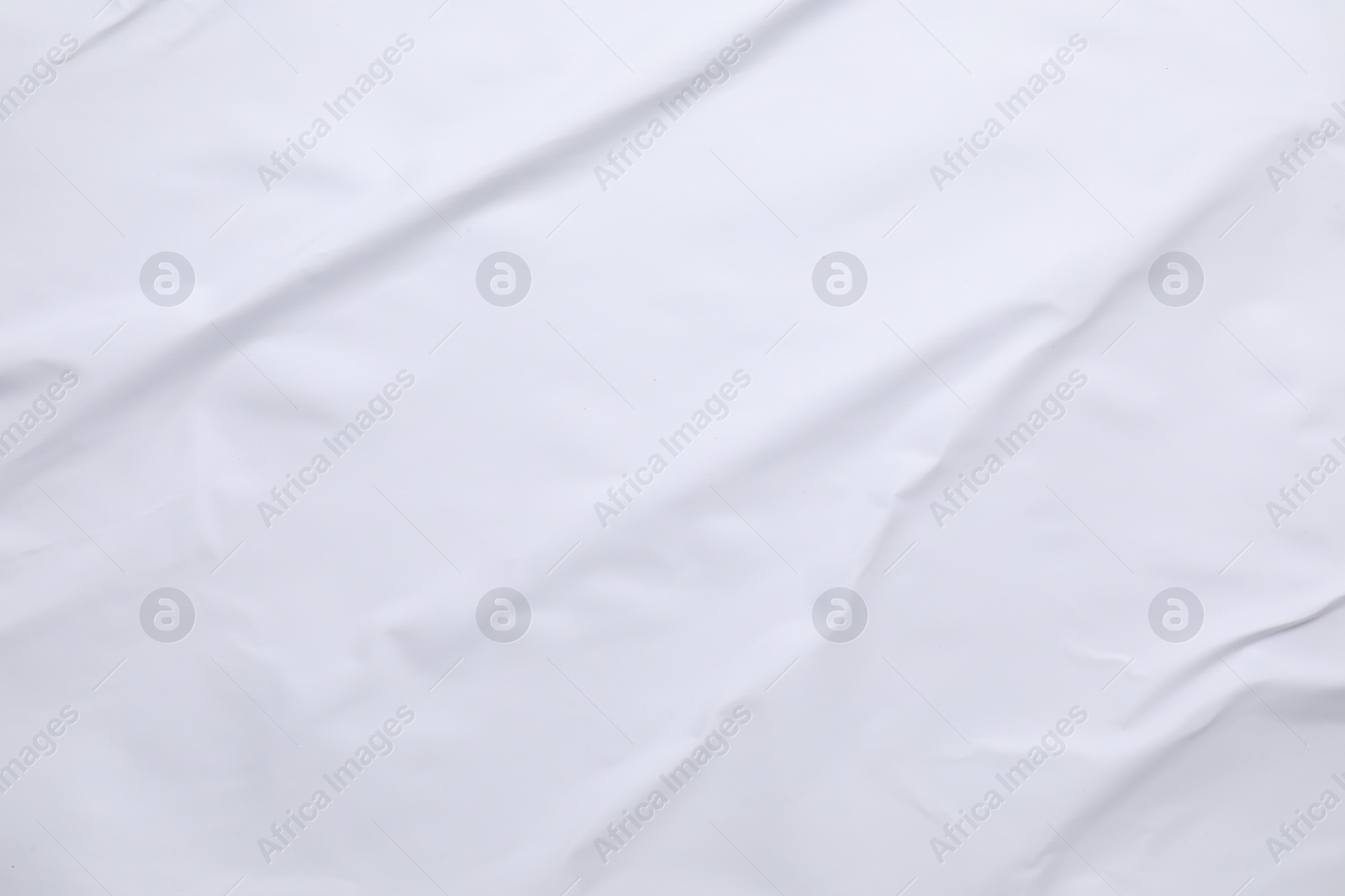 Photo of White crumpled sheet of paper as background, top view. Wall poster