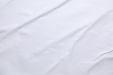 White crumpled sheet of paper as background, top view. Wall poster