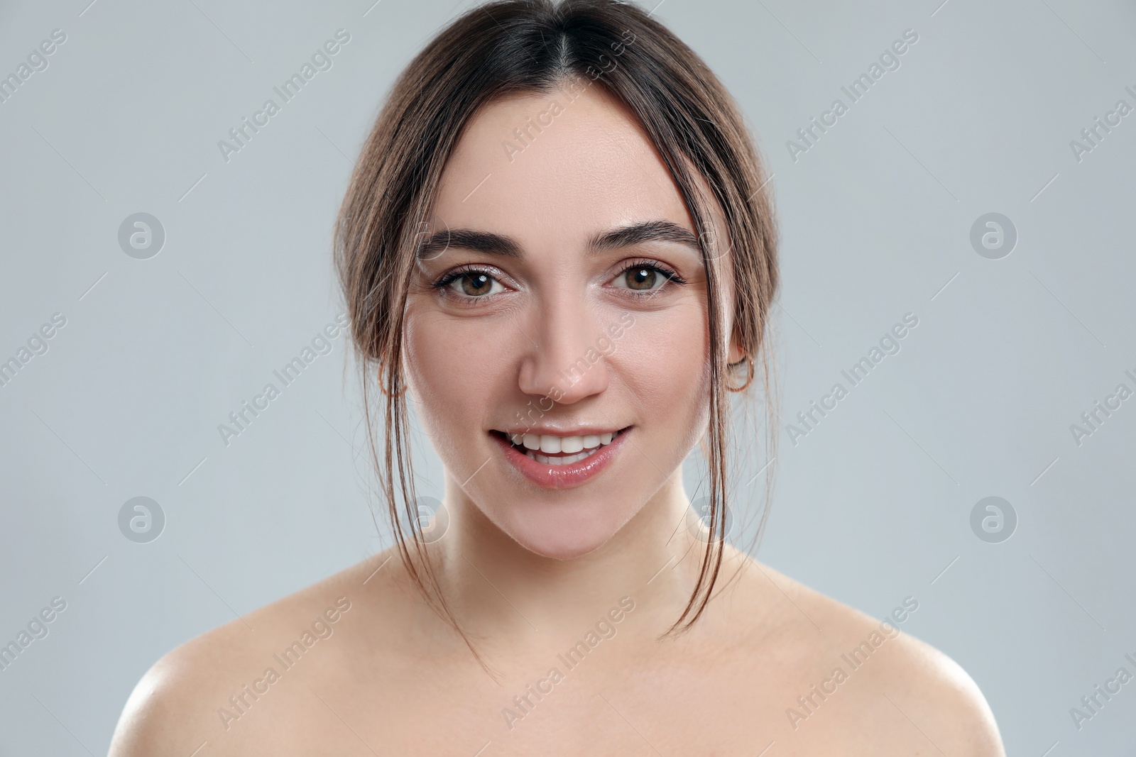 Photo of Portrait of beautiful woman on grey background