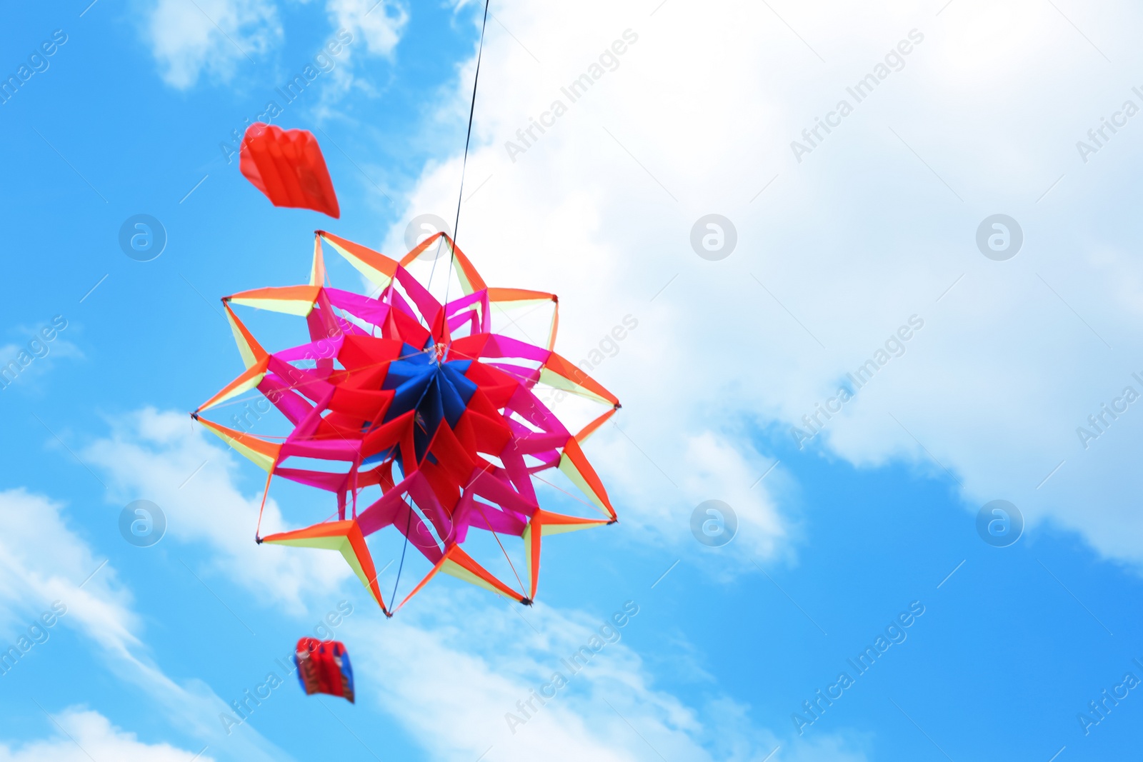 Photo of Beautiful kite drifting in blue sky