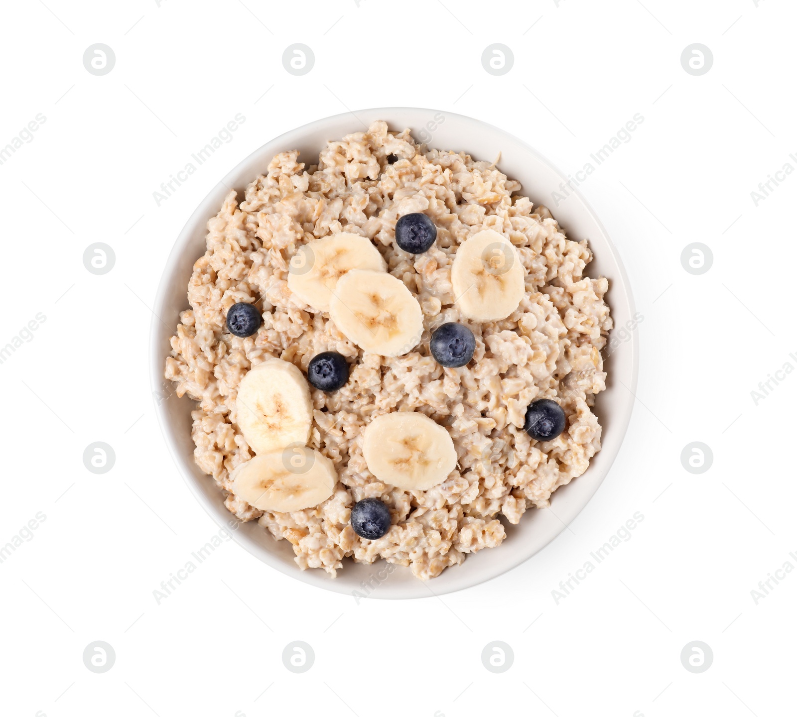 Photo of Tasty boiled oatmeal with blueberries and banana in bowl isolated on white, top view