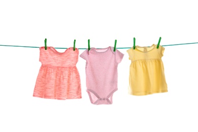 Photo of Baby clothes on laundry line against white background