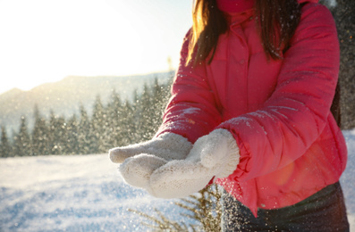 Young woman having fun outdoors on snowy winter day, closeup