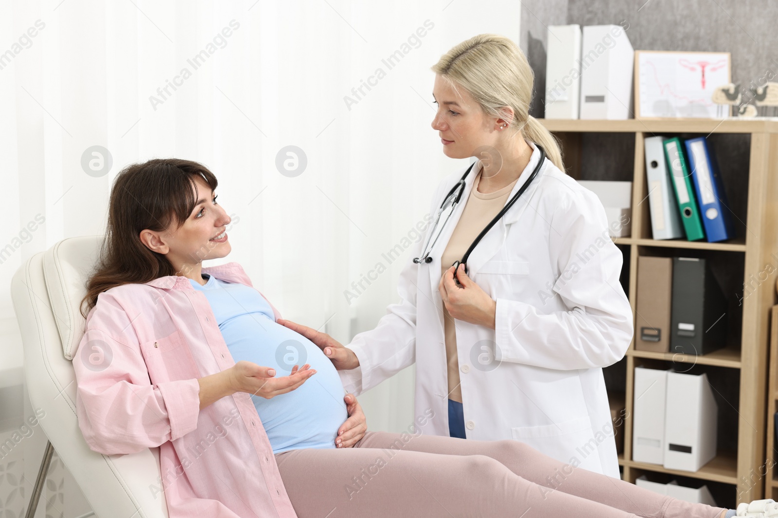 Photo of Happy pregnant woman having doctor appointment in hospital