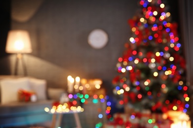 Photo of Blurred view of stylish room interior with decorated Christmas tree