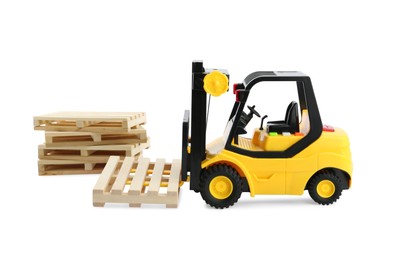 Photo of Toy forklift truck with wooden pallets on white background