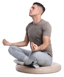 Photo of Handsome man meditating on white background. Harmony and zen