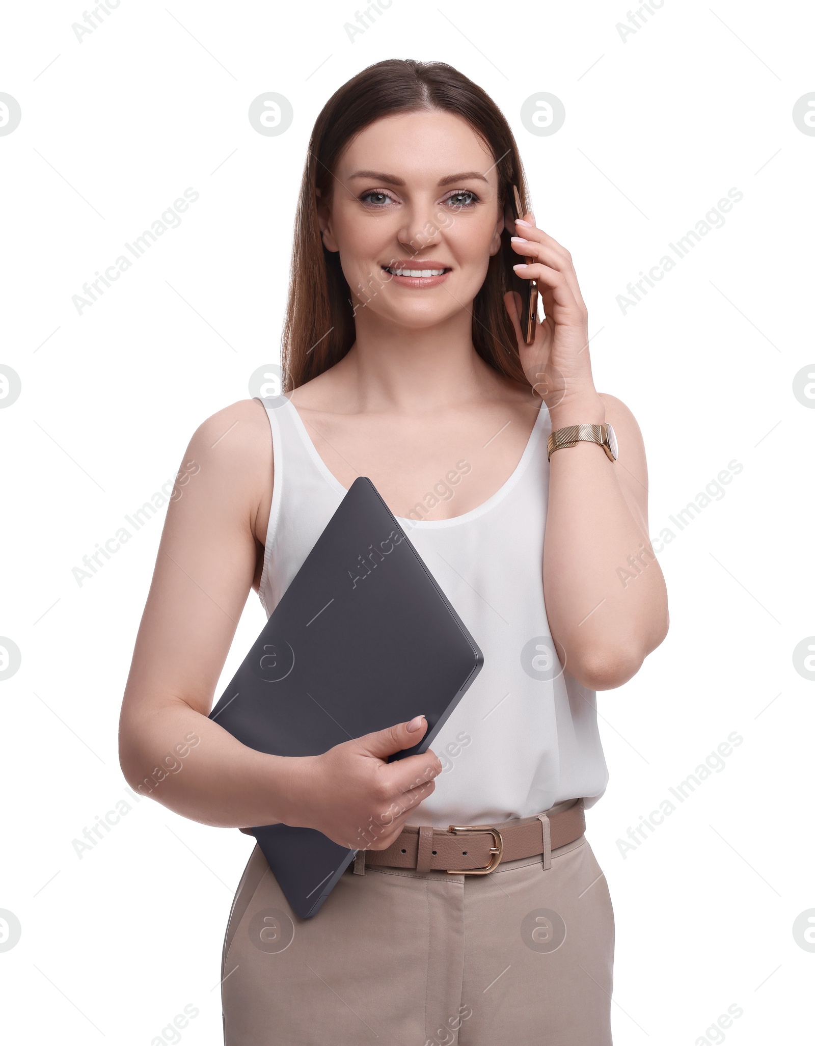 Photo of Beautiful businesswoman with laptop talking on smartphone against white background