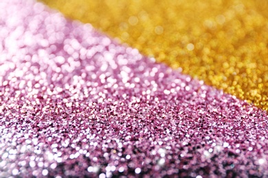 Photo of Gold and rose glitter as background, closeup