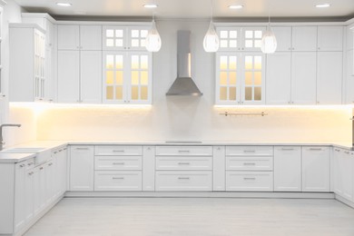 Photo of Modern light kitchen interior with stylish furniture