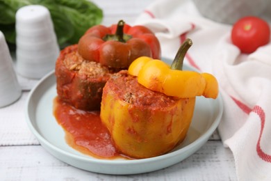 Photo of Delicious stuffed bell peppers on white wooden table, closeup