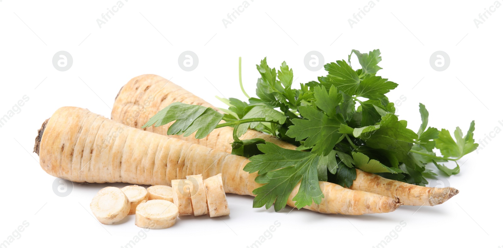 Photo of Raw parsley roots and bunch of fresh herb isolated on white
