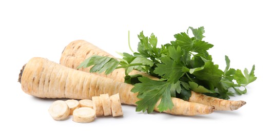 Raw parsley roots and bunch of fresh herb isolated on white