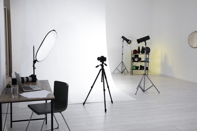 Photo of Photo studio interior with set of professional equipment and workplace