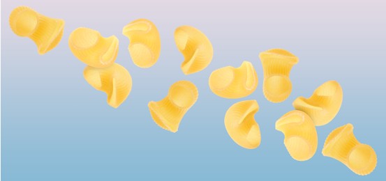 Image of Raw horns pasta flying on color background