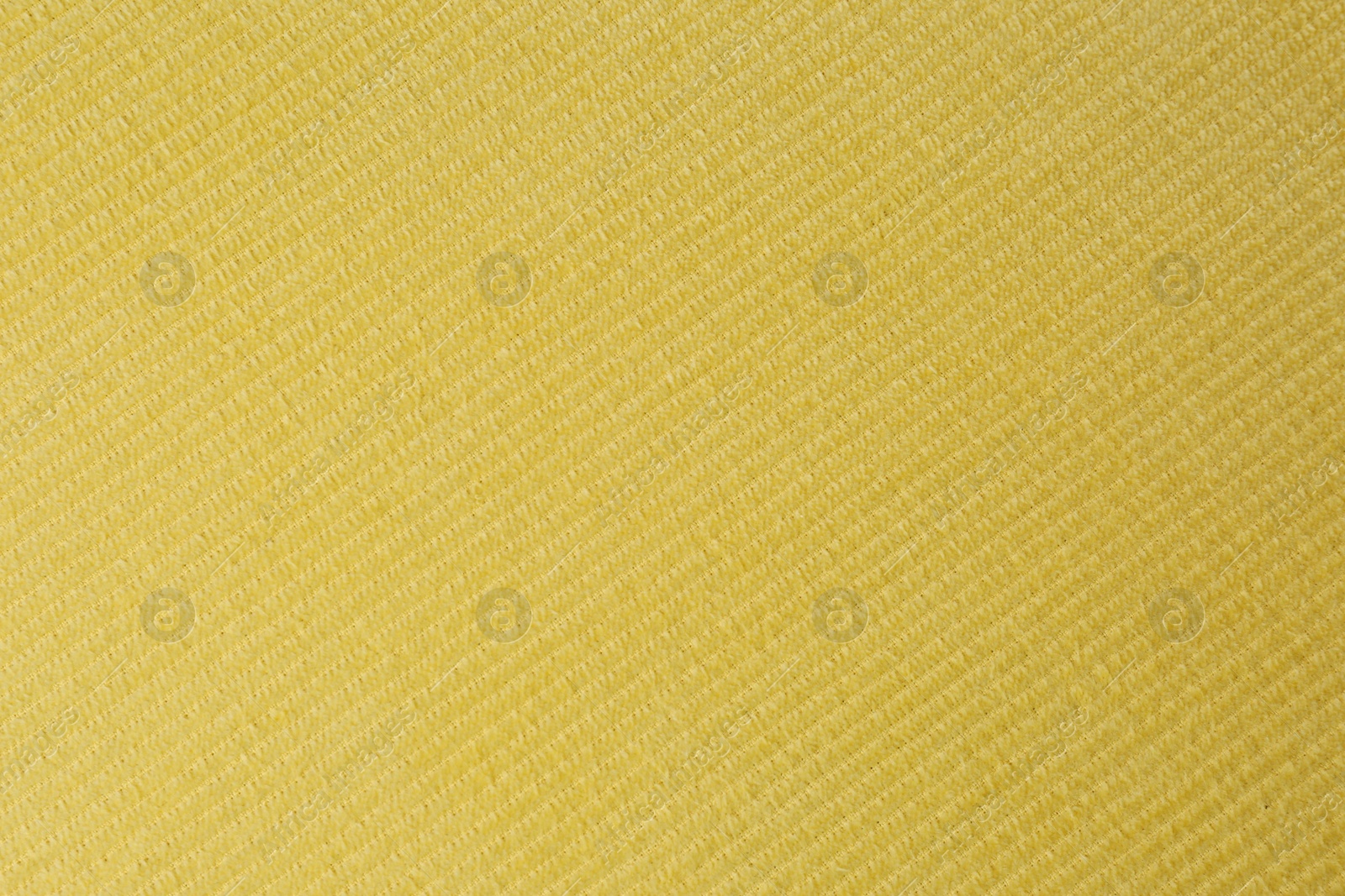 Photo of Yellow beach towel as background, top view