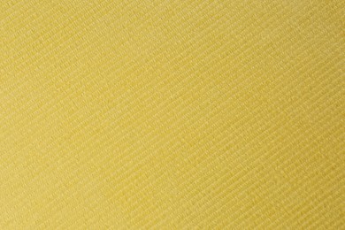 Photo of Yellow beach towel as background, top view