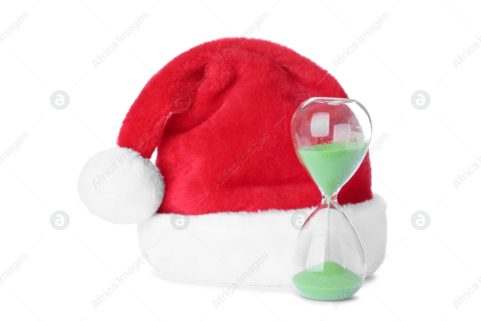 Photo of Hourglass and Santa hat on white background. Christmas countdown