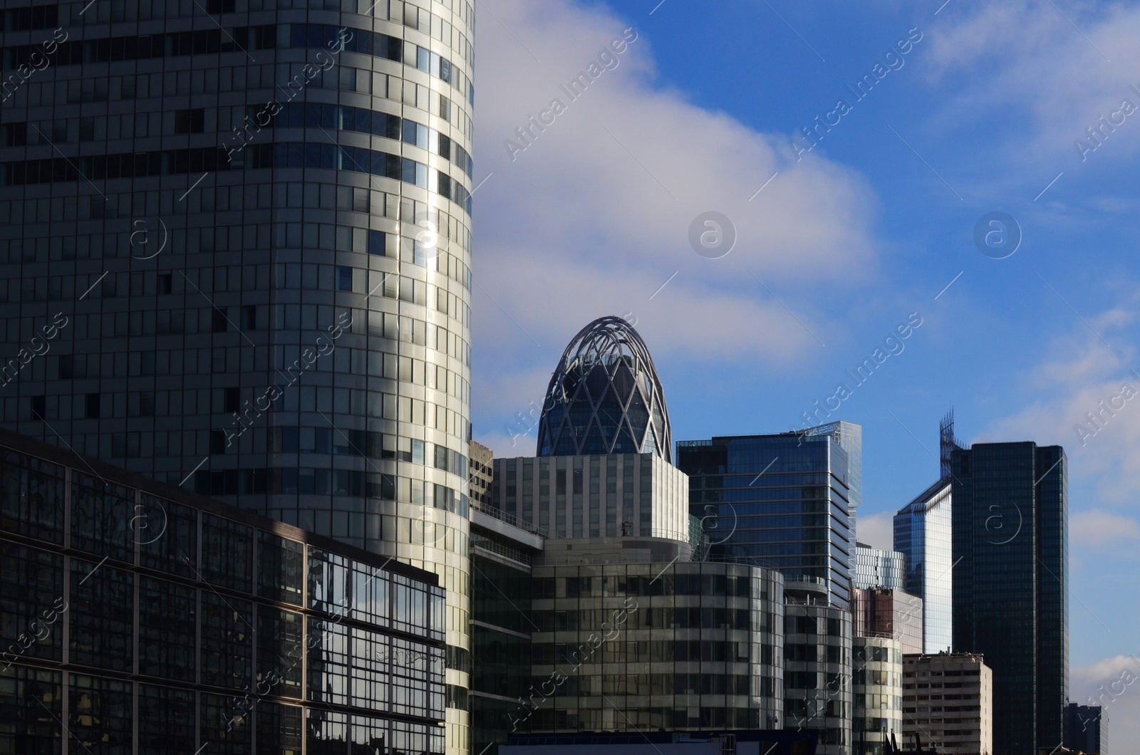 Photo of Exterior of different modern skyscrapers against blue sky