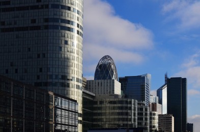 Exterior of different modern skyscrapers against blue sky